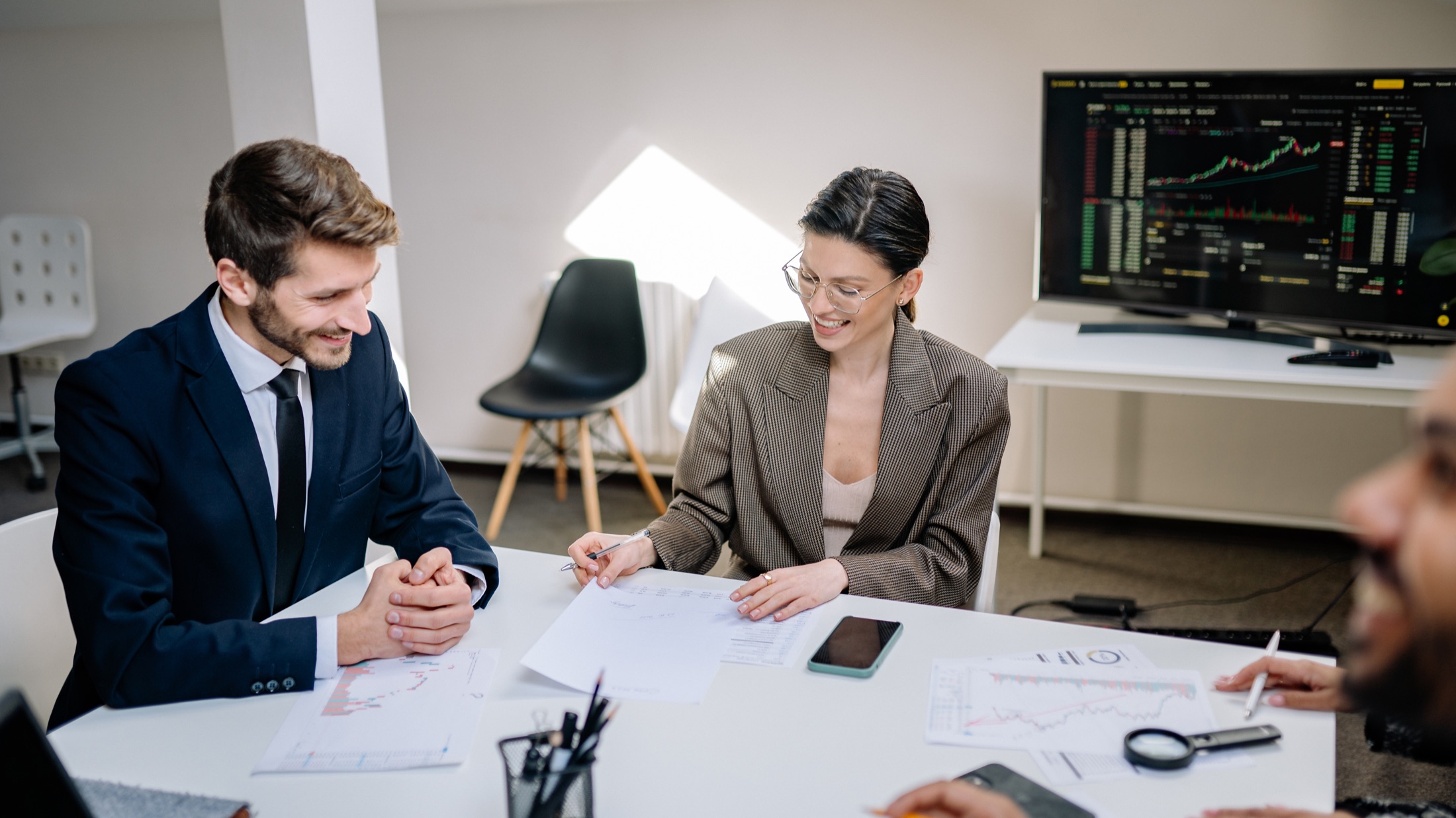 Colleagues reviewing printed information during an analytics discussion
